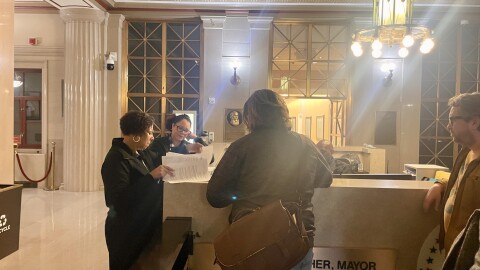 Organizers with Our City Our Say hand Columbus City Clerk Toya Johnson a charter amendment proposal that could change the city's hybrid council district system to a true ward system.