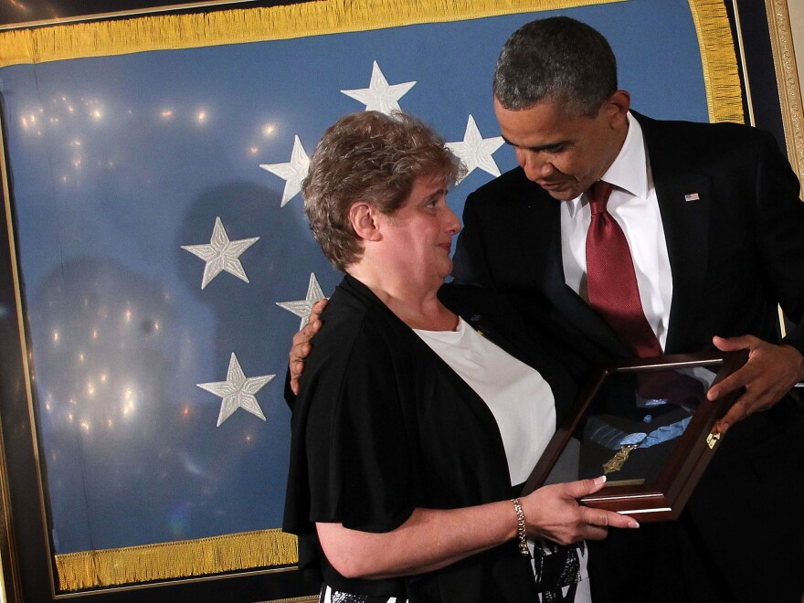 President Obama presents the Medal of Honor to Rose Mary Sabo, widow of Army Spc. Leslie Sabo. Sabo was awarded the nation's highest military decoration posthumously for his actions on May 10, 1970, while serving as a rifleman in Cambodia during the Vietnam War.