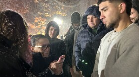Family members of Alex Gonzalez speak to him on a call from the Buffalo Federal Detention Center during a snow-filled rally outside the James M. Hanley Federal Building in Syracuse.