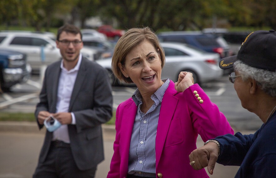 Iowa's Republican Governor Kim Reynolds greets a supporter of Iowa U.S. Senator Joni Ernst, also a Republican, ahead of the senator's first debate against her Democratic challenger Theresa Greenfield outside Iowa PBS studios in Johnston.