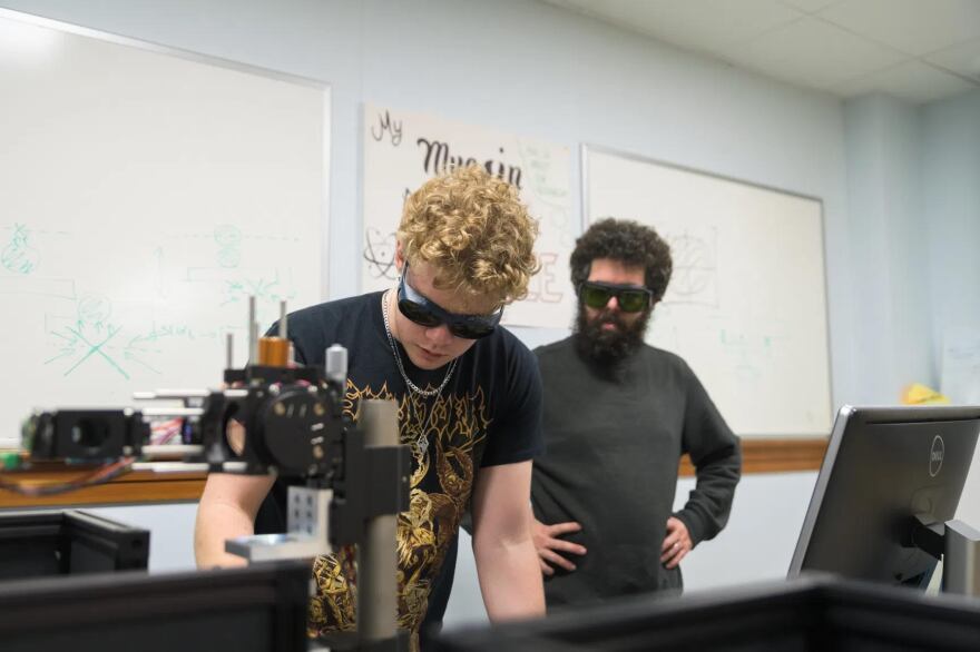 Two people in googles in a science lab.