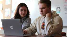 Juneau-Douglas High School: Yadaa.at Kalé seniors Jade Clements and Kyra Wood sit in college and career advisor Jessica Dean’s classroom on Monday, Feb. 26, 2024. (Katie Anastas/KTOO)
