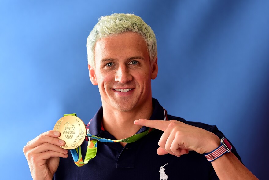 Ryan Lochte poses with his gold medal on the <em>Today</em> show set on Copacabana Beach last week.