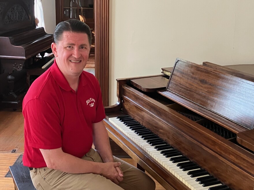 Josh Duffee of Davenport, a busy drummer, Bix-era expert and member of the Bix Society advisory board for Common Chord, sits at the 1925 piano (not original to the house) at the Bix home Monday, Aug. 10, 2026.