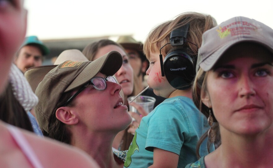 Mother holding son wearing protective ear muffs during the Saturday shows