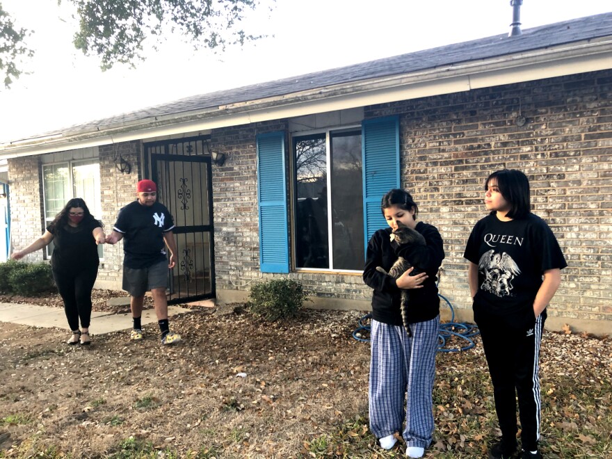 Jesse Yebra, 18, helps his mom, Trista, navigate the yard in sandals. He and his younger sisters have been learning virtually for a year.