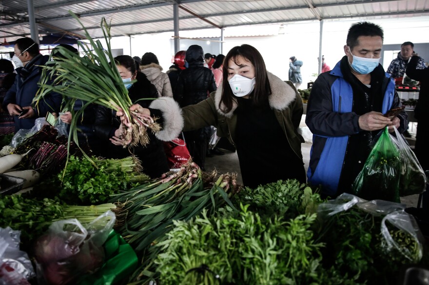 In Wuhan, China, and other parts of East Asia, wearing masks in public has been commonplace since the SARS outbreak in the early 2000s. This photo was taken on January 23, about a week before China called on citizens to wear masks as a way to stem the spread of the novel coronavirus.