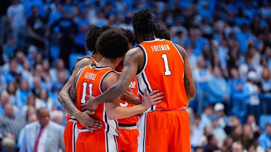 Syracuse guard Nait George (11, Orange) and forward Donnie Freeman (1, Orange) huddle up during the Orange’s game against North Carolina.