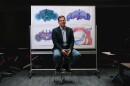 Davi Bock, a researcher in UVM’s Department of Neurological Sciences, is pictured with three-dimensional visualizations connected to his research mapping neural circuits.