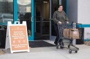 Taylor Desert, a TSA agent, leaves Gleaners Food Bank after picking up groceries in Indianapolis, Monday, March 23, 2026.