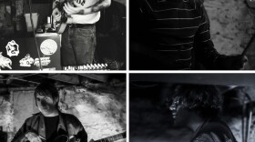 Four men play music in a dark basement.