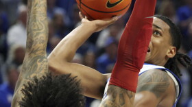 Kentucky's Rob Dillingham, right, shoots while pressured by Arkansas' Jeremiah Davenport (24) during the second half of an NCAA college basketball game Saturday, March 2, 2024, in Lexington, Ky. Kentucky won 111-102.(AP Photo/James Crisp)