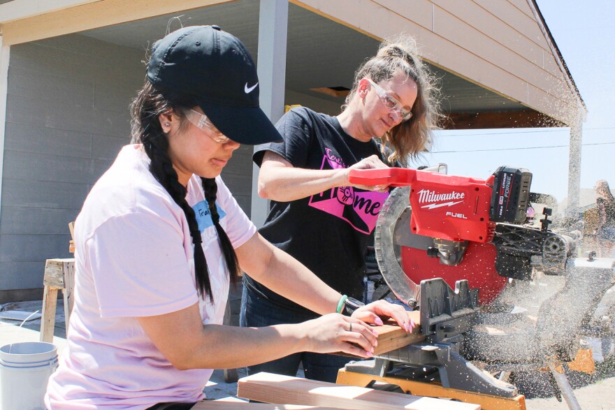 Trang Nguyễn and Lisa Mayfield, who are realtors with Berkshire Hathaway, work on a house on Piatt Street for Habitat Women Build. After Habitat is done with these homes, it will start on the Pope Leo Village.