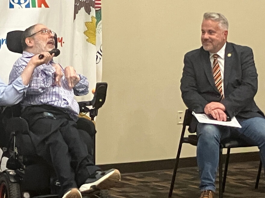 Robert Peterson (left), a Rock Island disability advocate, speaks Wednesday, Sept. 23, as U.S. Rep. Eric Sorenson looks on.