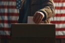 Picture of man dropping off ballot in election.