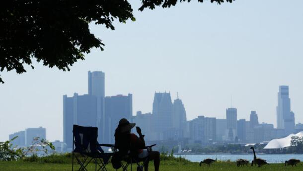 A woman sits in the shade on Monday, July 13, 2026, in Detroit. (Paul Sancya/AP)