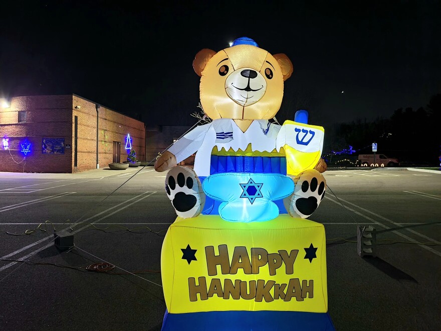 inflatable bear with menorah, dreidel, kippah