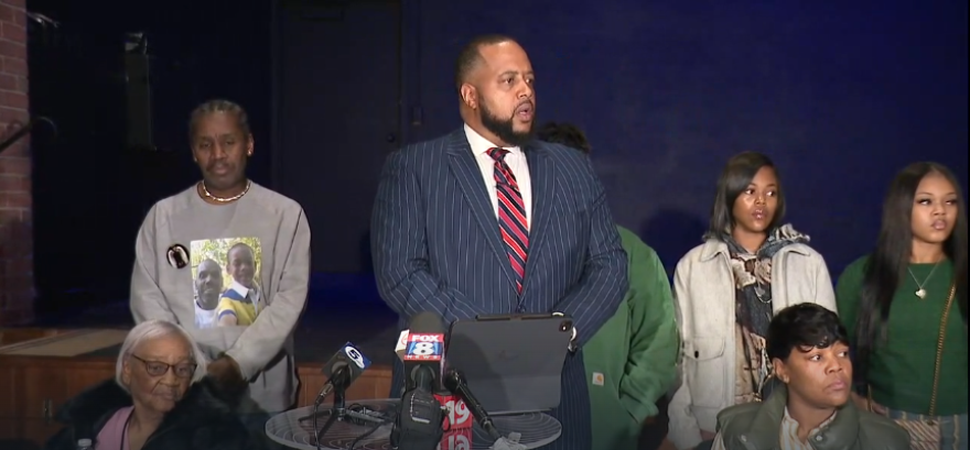 Robert Gresham (center), attorney for Jazmir Tucker's family, speaks about the lawsuit the family filed against the city of Akron on Nov. 25, 2025. 