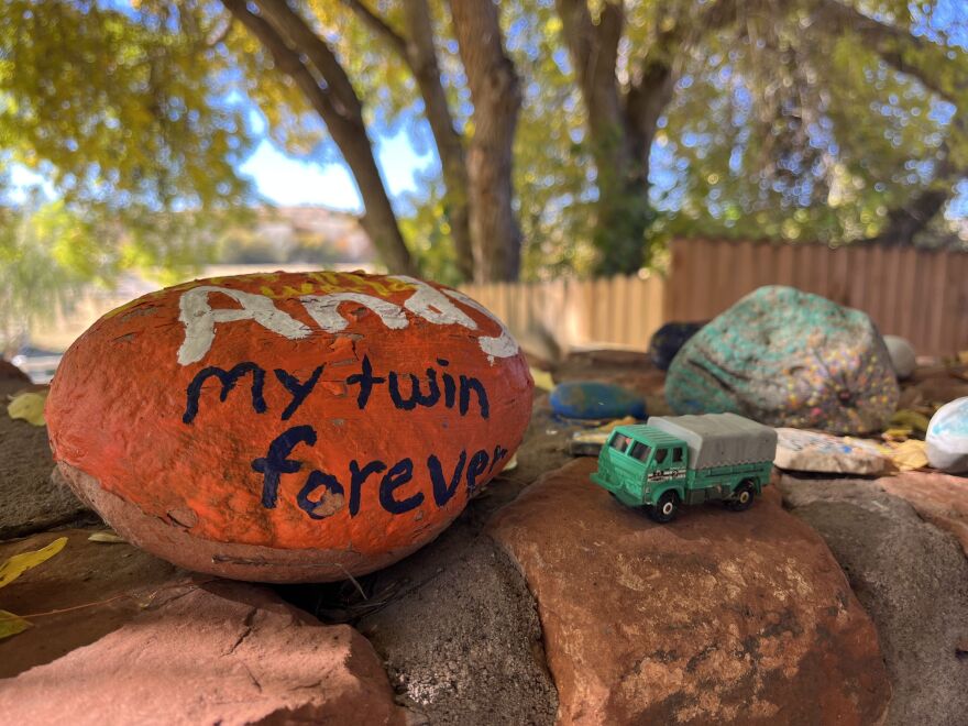 Painted rocks and other mementos of departed loved ones adorn an area designed for quiet contemplation on the Selah Carefarm in Cottonwood, Ariz.