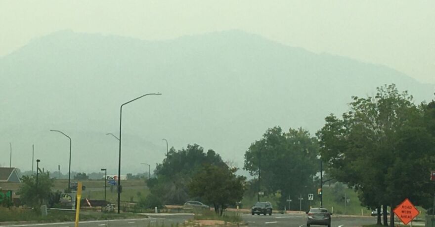 A hazy view of the Flatirons from South Boulder Road in Boulder, Colorado.