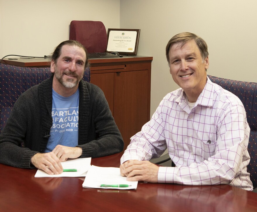 :  Faculty Association Lead Sean Colcleasure and Board Chair Gregg Chadwick sign the new 3-year agreement.