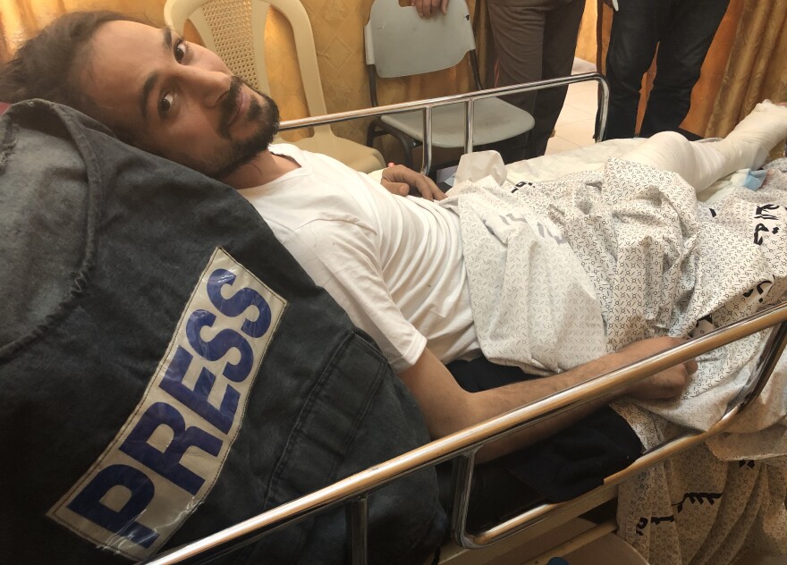 Adham Hajjar, 32, says he was wearing a vest marked "PRESS" when he was shot in the leg while covering protests at the Gaza-Israel border on Friday