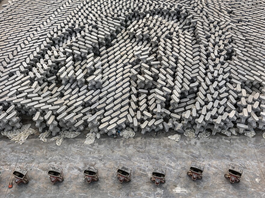 A tetrapod factory in Dongying, China. These concrete blocks are dropped into the ocean to create a barrier that protects low-lying oil refineries from rising sea levels. According to a recent <a href="https://science.sciencemag.org/content/351/6269/aad2622">scientific review</a>, human beings have now produced enough concrete to cover the entire globe in a 2-millimeter thick layer.