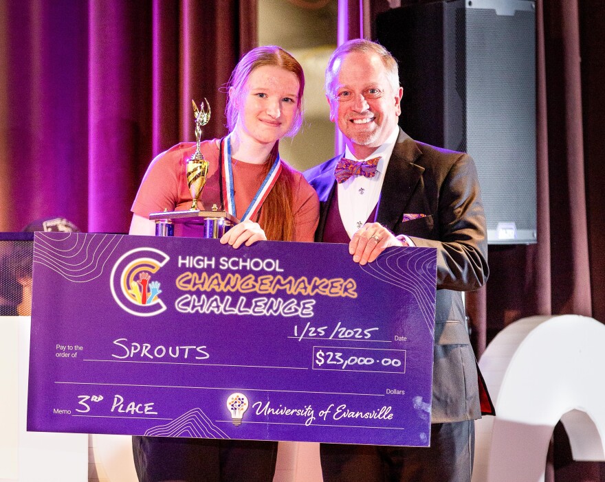 Third place winner Olivia Cooper stands with UE President Pietruszkiewicz.