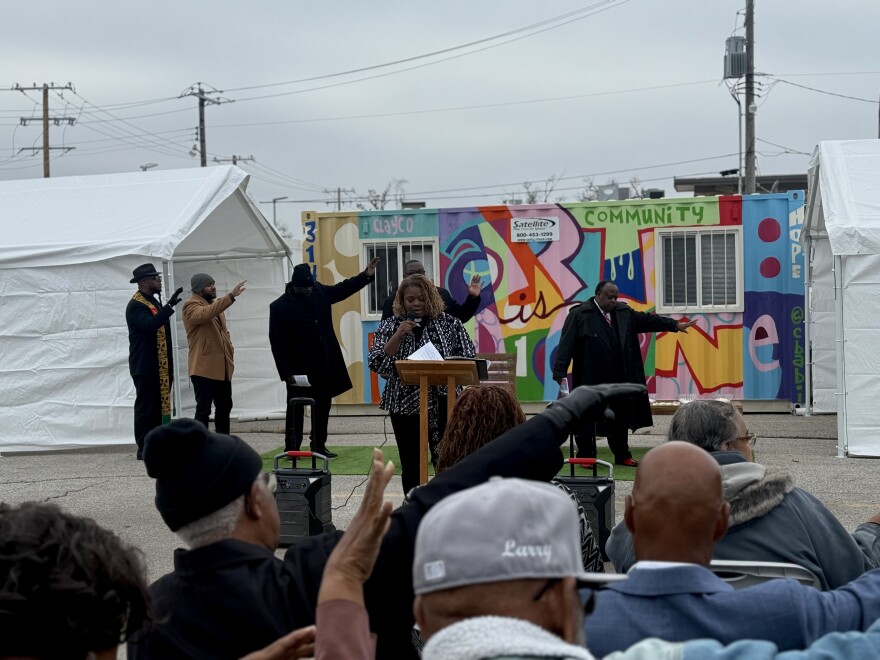 The Rev. Dietra Wise Baker, church ministers and former pastors reach their hands toward Centennial Christian Church to pray for its next chapter.