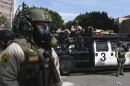 FILE - Law enforcement officers stand guard during a protest June 14, 2025, in Los Angeles. (AP Photo/Ethan Swope, File)