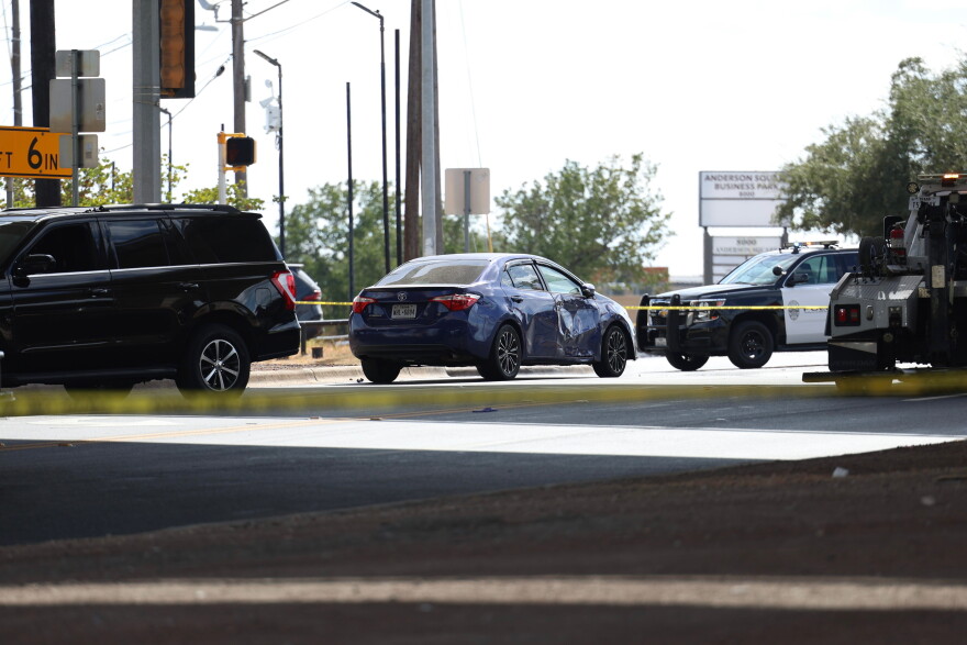 A blue car with damage to its passenger-side door was seen at the scene of a shooting by an ICE agent in North Austin on Sunday afternoon.