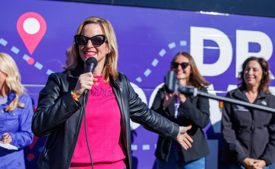 Democratic gubernatorial nominee Jocelyn Benson speaks in East Lansing, Mich., on Oct. 22, 2026, during the first stop on her statewide "Driving Down Costs" bus tour.