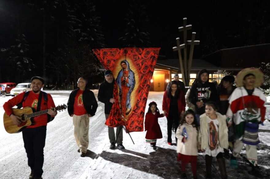 Residents sing and carry a banner depicting Our Lady of Guadalupe outside of St. Paul Catholic Church in Juneau on Dec. 10, 2023. (Clarise Larson/KTOO)
