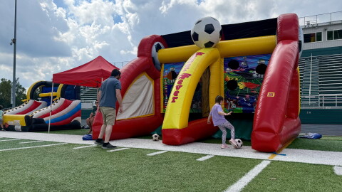 A girl and her father kick soccer balls at the quiet carnival in Macedonia. 