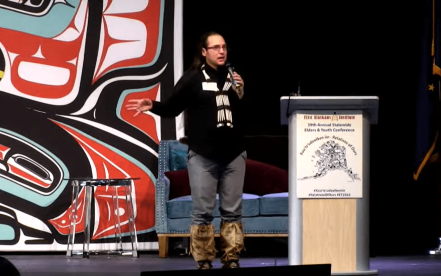 Joel Isaak, the Alaska Department of Education and Early Development’s tribal liaison, speaks about SB34 at the Elders and Youth Conference in Anchorage on Oct. 17, 2022. (Screenshot from First Alaskans Institute livestream.)