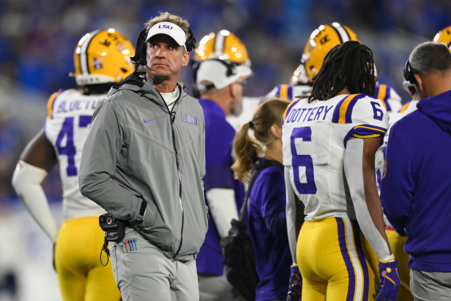 LSU head coach Lane Kiffin, left, looks on during the first half of an NCCA college football game against Kentucky, Saturday, Oct. 10, 2026, in Lexington, Ky. (AP Photo/Tanner Pearson)