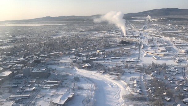 A frozen, snow-covered river runs through frosty building in downtown Fairbanks