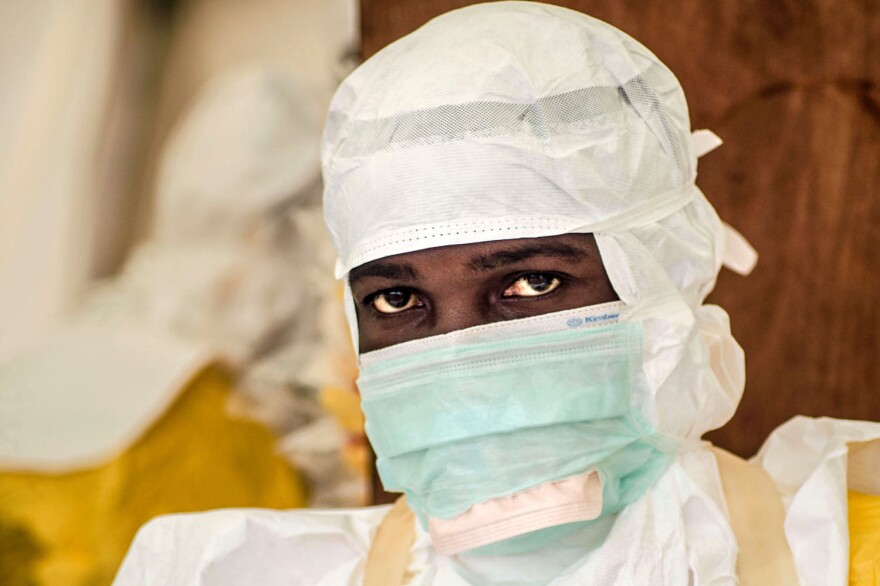 A health worker just needs goggles to complete the protective suit for the Ebola treatment center in Kailahun, Sierra Leone.