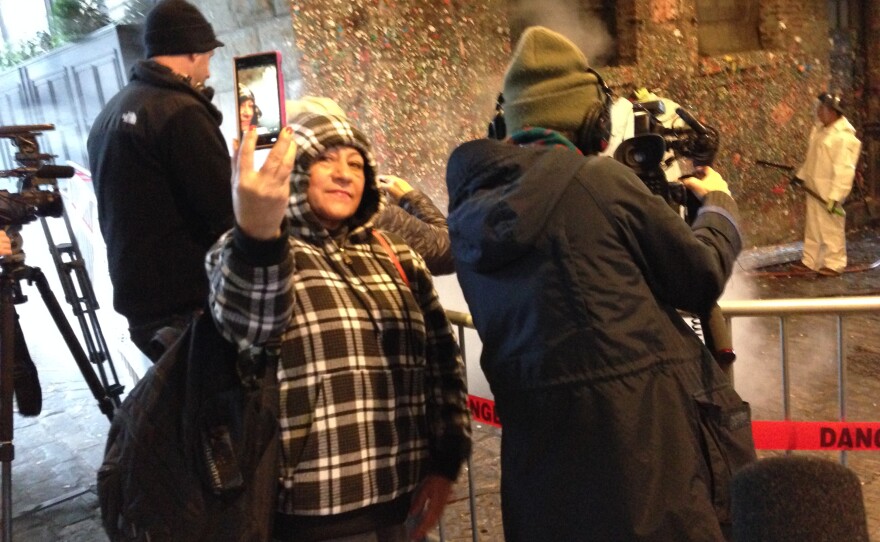 People get selfies of the cleaning of the gum wall at Pike Place Market on Tuesday, Nov. 10, 2015.