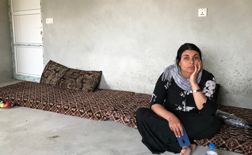 Kamo Zandinan sits in a friend's home in a village in Sinjar in northern Iraq. She believes an older daughter is alive and still in Iraq. The girl was 13 when she was taken by ISIS. "I told them she is sick, but they tore her clothes in front of me," says Zandinan. "We were holding onto each other but they beat me with a stick and she fell on the ground and I couldn't do anything."