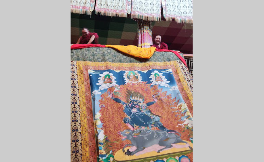 Monks unfurl a tankha painting at Tawang Monastery.