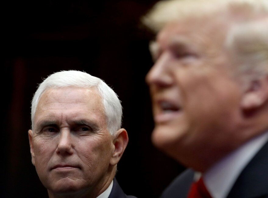 Vice President Pence and President Trump listen during a conference call with the International Space Station on Oct. 18.