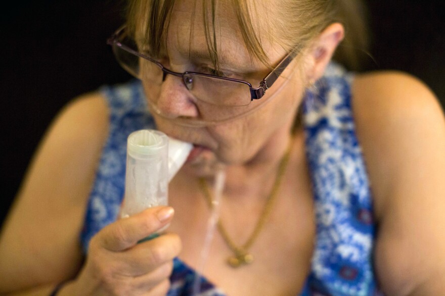 Juanita Milton, who suffers from COPD, uses her nebulizer with albuterol sulfate at her home in Live Oak, Texas.