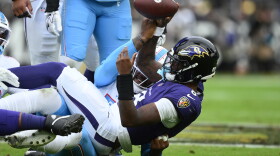Baltimore Ravens quarterback Lamar Jackson (8) is sacked by Tennessee Titans defensive end Jacob Martin, left, during the first half of an NFL football game in Baltimore, Sunday, Oct. 4, 2026. (AP Photo/Nick Wass)