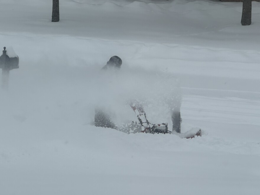 Image of man using a snow blower to clear a Beavercreek sidewalk. He is resident Eric Pauling. 