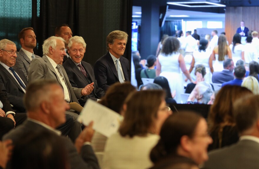Buffalo Bills owner Terry Pegula, B. Thomas Golisano, former President Bill Clinton and Special Olympics Chairman Timothy Shriver watch as graduates process into the room for the Golisano Institute for Business & Entrepreneurship’s graduation ceremony on Friday, Aug. 14, 2026.