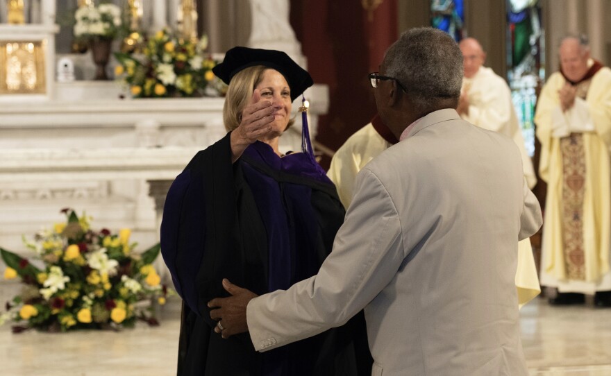 Judge Calvin Johnson hugs Dean of Loyola University Law School Madeleine Landrieu after receiving formal apology at the Law Baccalaureate Mass at the Holy Name of Jesus Church, May 13, 2022.