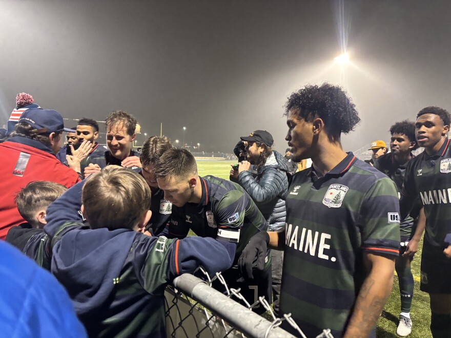 Hearts of Pine players signing autographs after their 4-0 win.