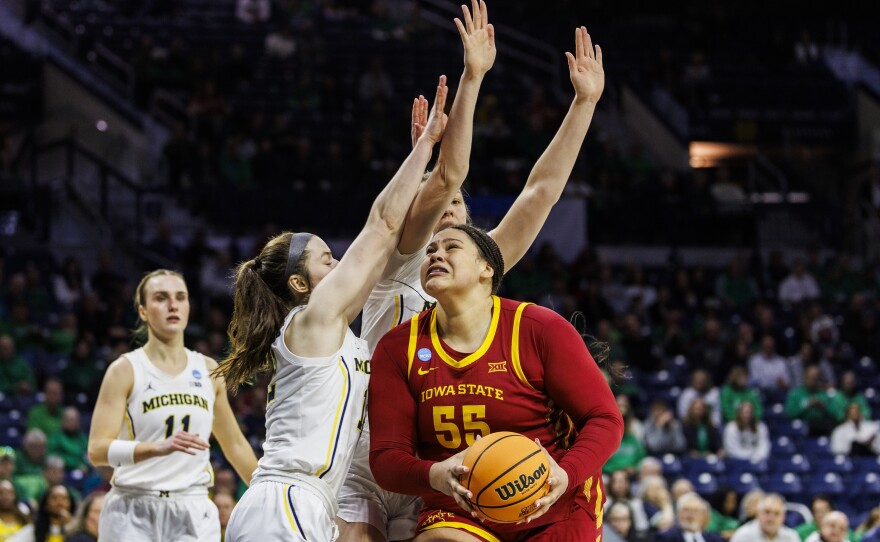 Iowa State center Audi Crooks (55) drives as Michigan guard Syla Swords (12) defends during the first half in the first round of the NCAA college basketball tournament, Friday, March 21, 2025, in South Bend, Ind. (AP Photo/John Mersits)