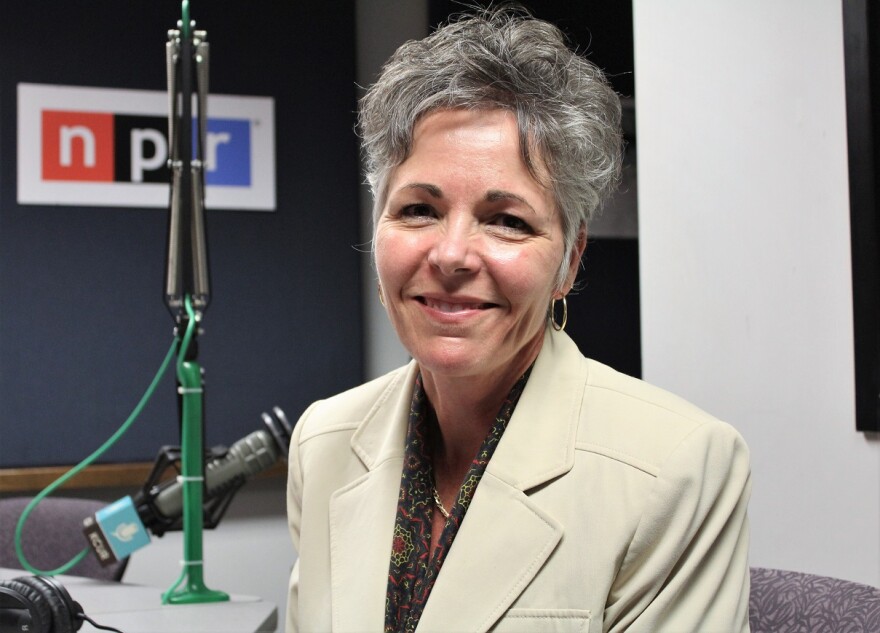 A picture of a women with gray hair in KCUR studio. Subject visable from chest up. 